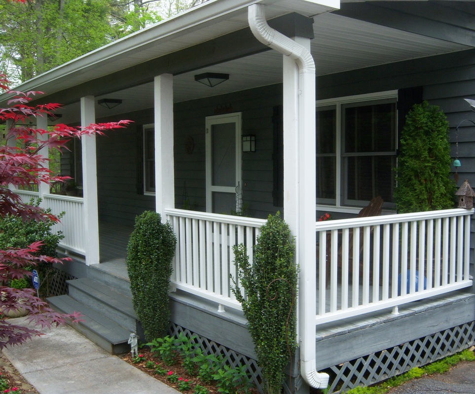 Porch renovation with new railing, shutters and light fixturesPicture