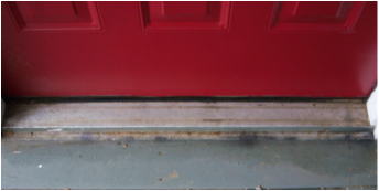 A dirty door sill clean up - before