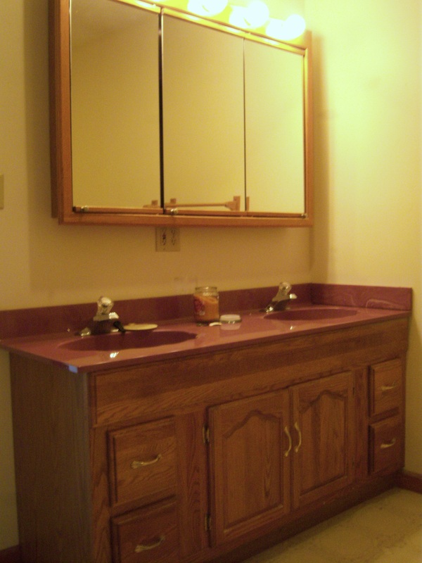 Replace bathroom vanity cabinets, counter and mirror and light fixturesPicture